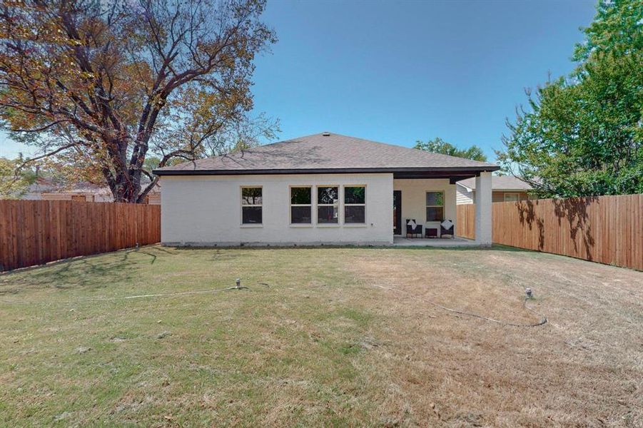 Back of property with a patio area and a yard