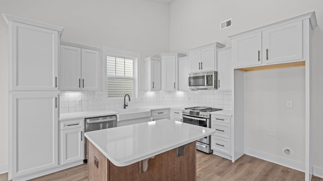 Modern kitchen with streamlined island for easy prep, storage, and gathering