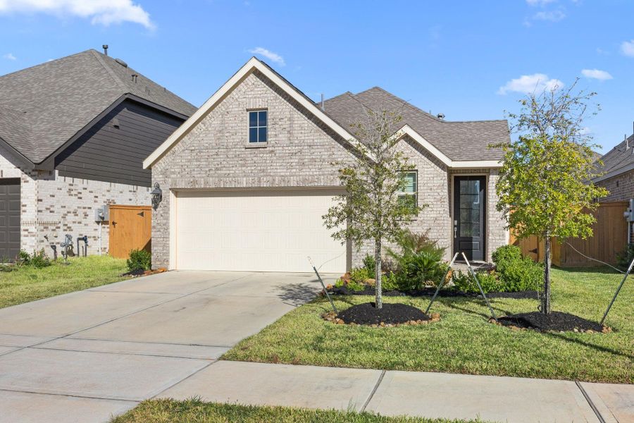 Front exterior of a new home in Sunterra: Avante Collection, Katy, TX, highlighting curb appeal (Image 21).