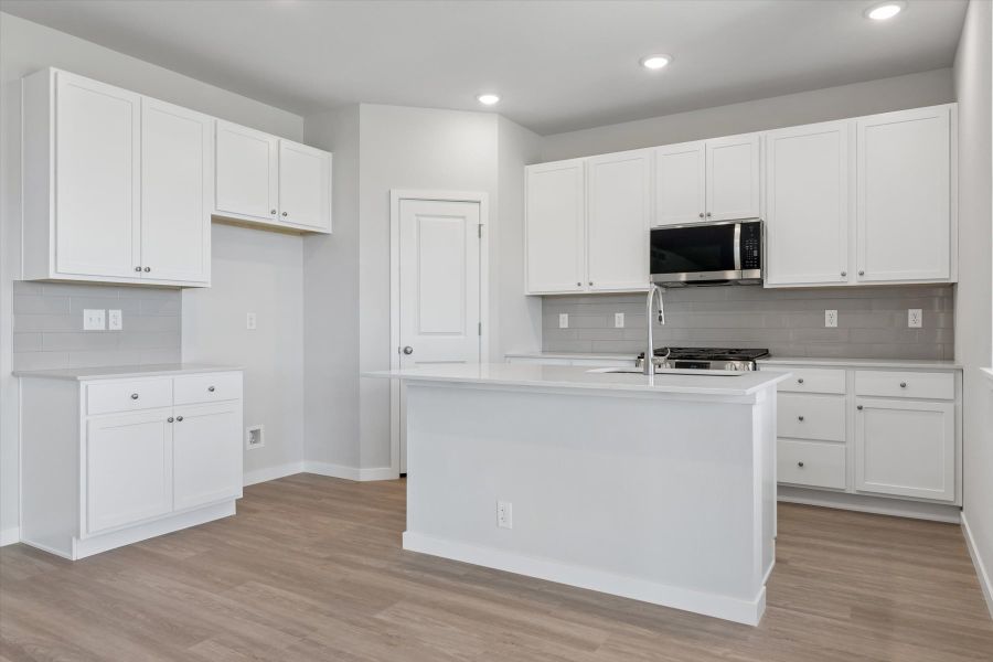 A kitchen with white cabinets. A kitchen with white cabinets.
