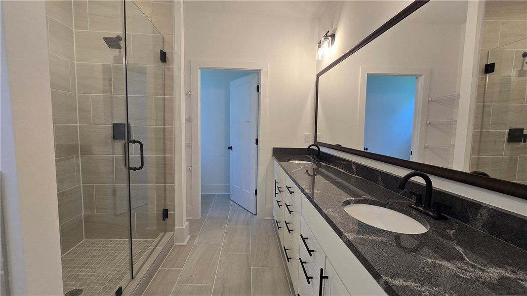 Granite counters and dual sinks define this bright