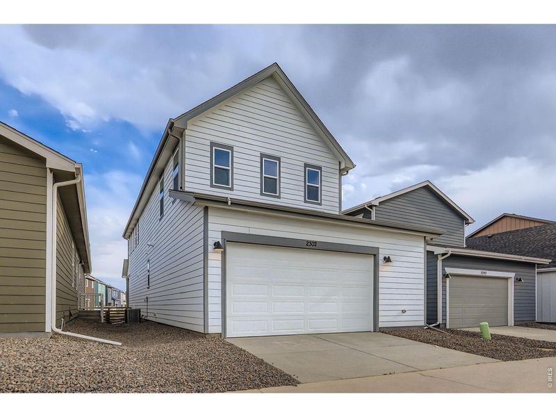 Front exterior of a new home in Waterfield, Fort Collins, CO, highlighting curb appeal (Image 21).