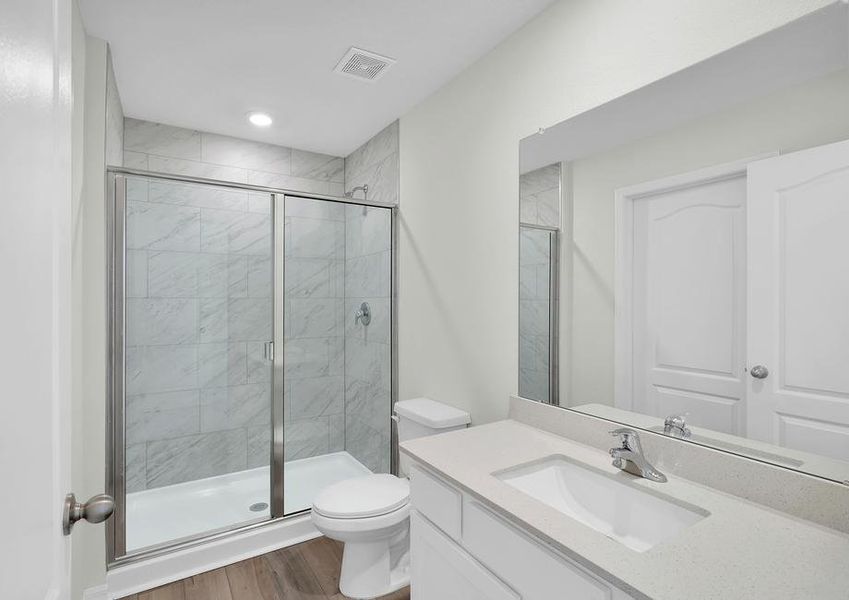 The master bath has a spacious, glass-enclosed shower.