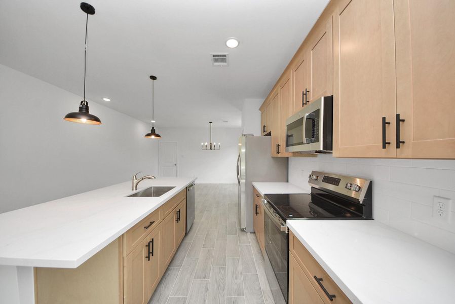 Kitchen showcases shaker-style cabinets, stainless steel appliances, and tile backsplash. Kitchen showcases shaker-style cabinets, stainless steel appliances, and tile backsplash.