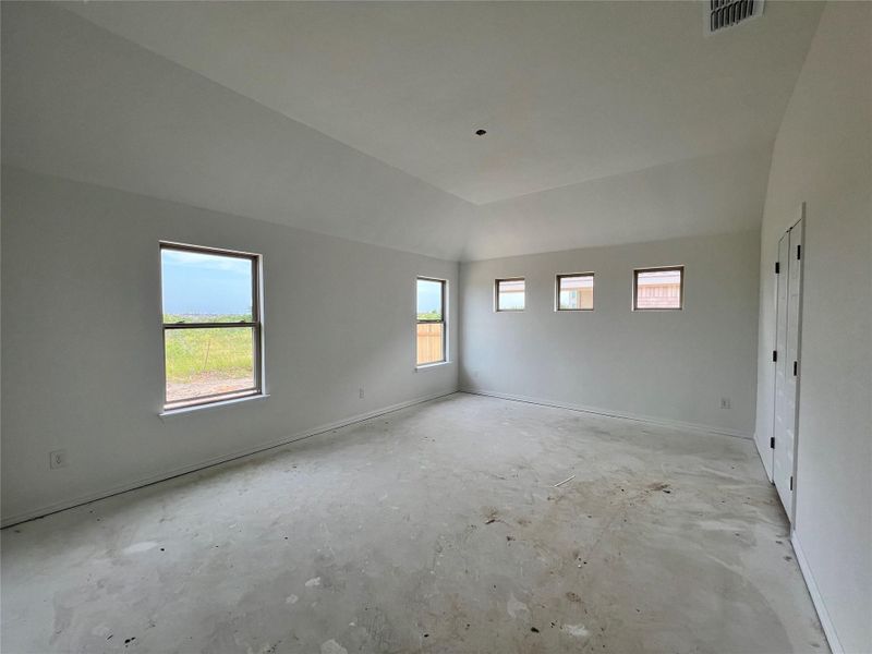 Spare room featuring baseboards and concrete flooring