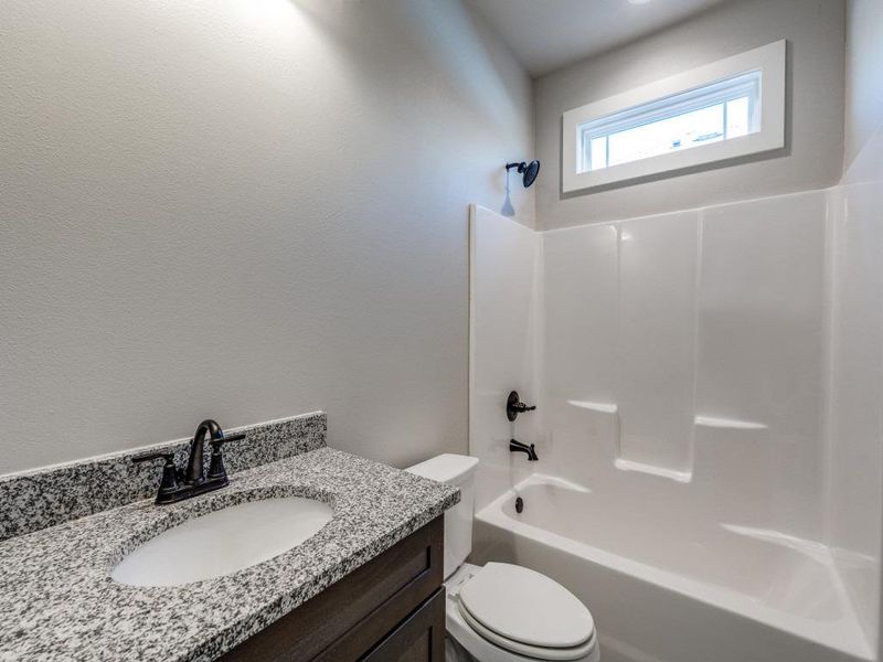 Full bath featuring bathing tub / shower combination, vanity, and toilet
