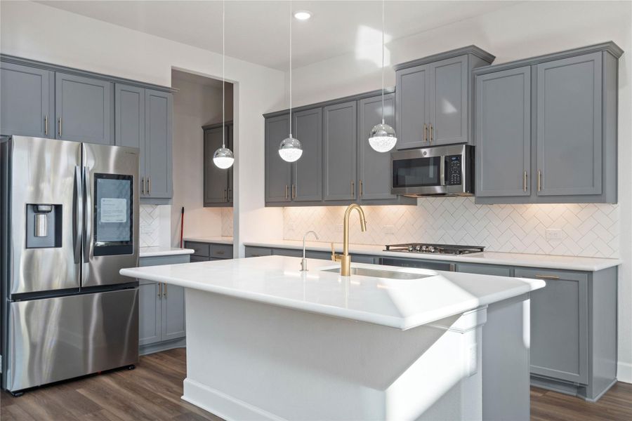 Smooth stone countertops and classic crown molding elevate this open-plan cooking space.