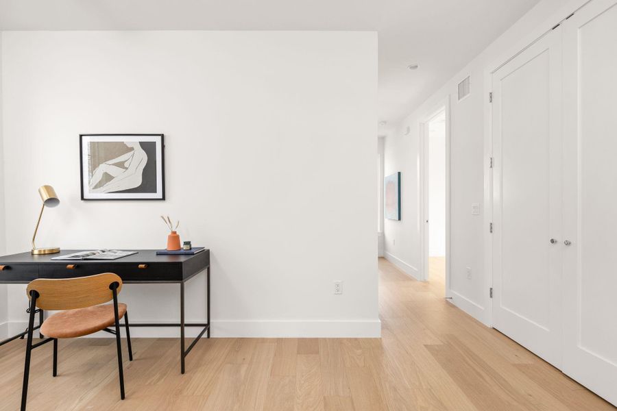 Office area with light wood-style flooring and baseboards Office area with light wood-style flooring and baseboards