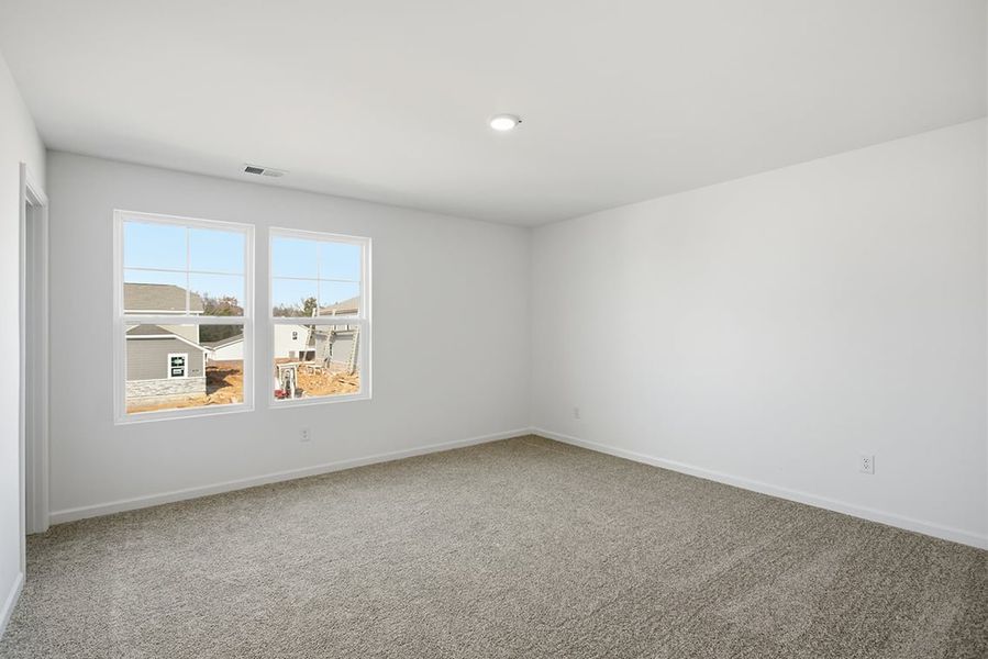 A room with a window and a carpet. A room with a window and a carpet.