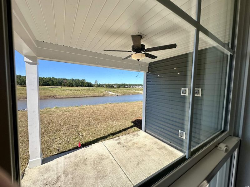 View of patio featuring a ceiling fan and a water view View of patio featuring a ceiling fan and a water view