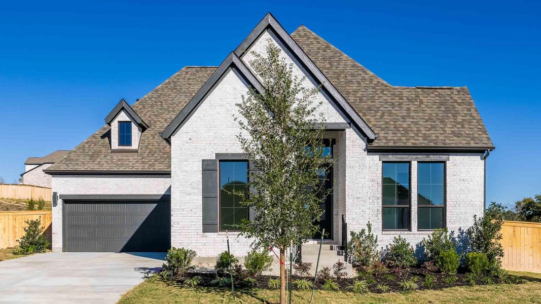 Front exterior of a new home in Nolina 60', Georgetown, TX, highlighting curb appeal (Image 1). Front exterior of a new home in Nolina 60', Georgetown, TX, highlighting curb appeal (Image 1).
