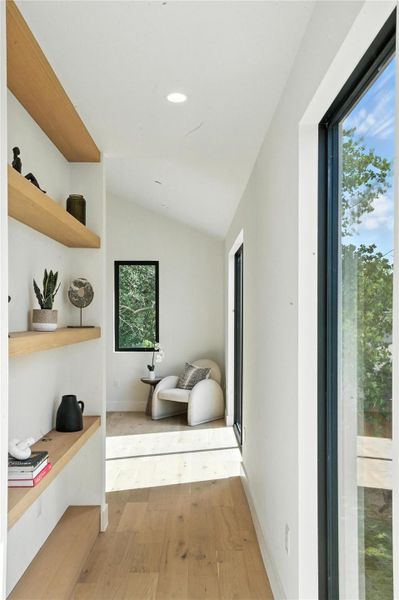 Bathroom featuring wood finished floors, vaulted ceiling, and recessed lighting Bathroom featuring wood finished floors, vaulted ceiling, and recessed lighting