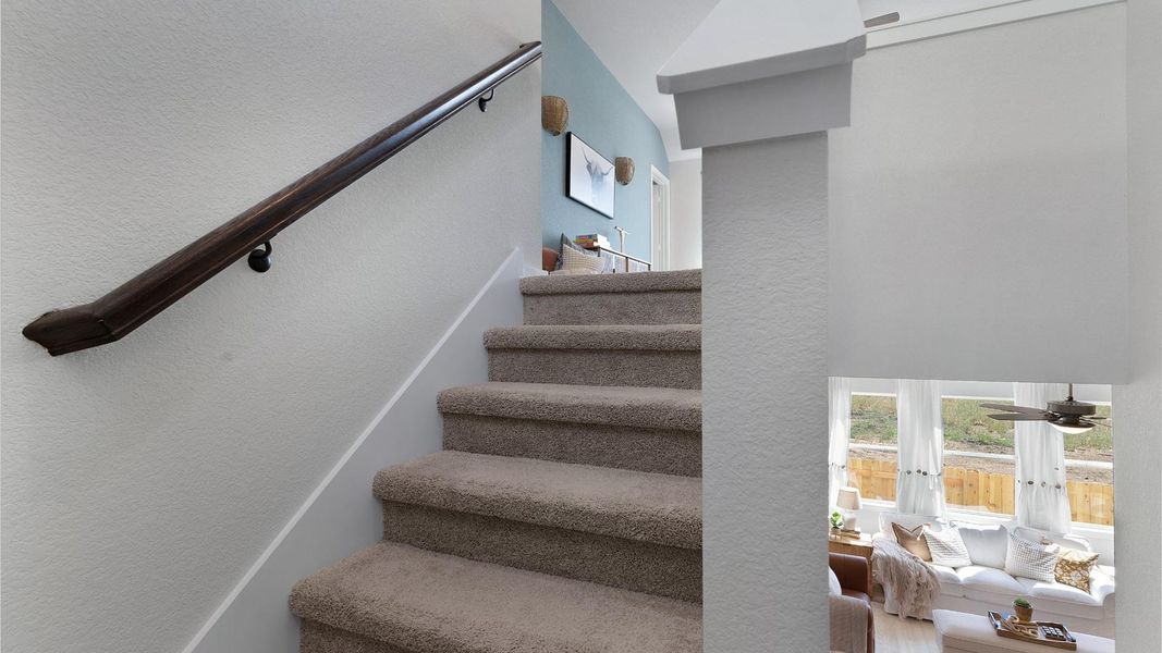 A plush carpeted staircase invites you to explore the upper level of this residence. A plush carpeted staircase invites you to explore the upper level of this residence.