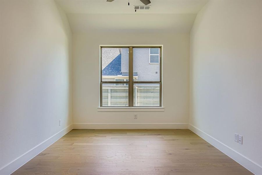 Spare room featuring light wood-style flooring and ceiling fan Spare room featuring light wood-style flooring and ceiling fan