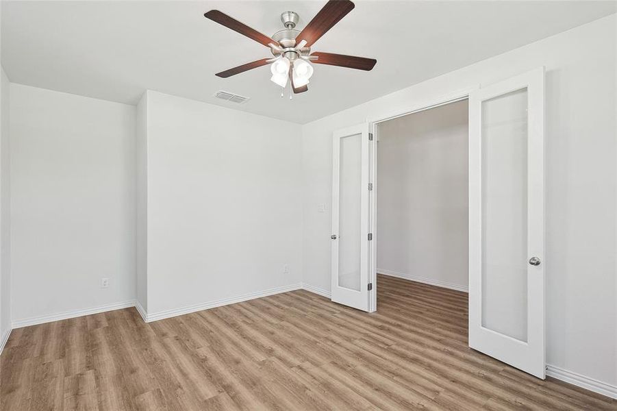 Unfurnished bedroom with light wood-type flooring and ceiling fan