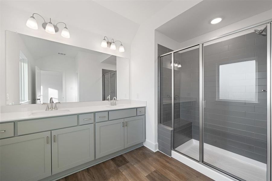 Bathroom with wood-type flooring, vanity, and walk in shower