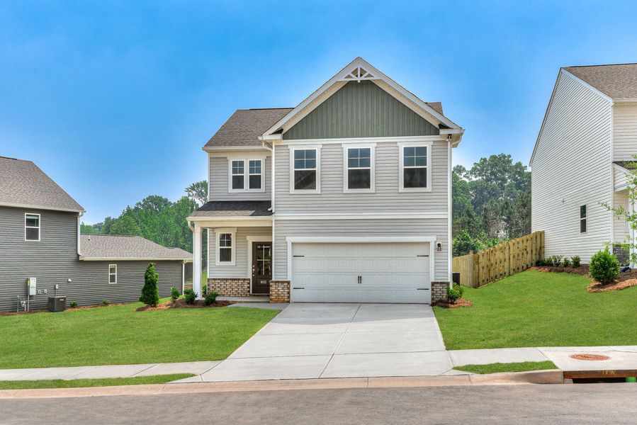 Front exterior of a new home in The Mill at Woodcreek Farms, Elgin, SC, highlighting curb appeal (Image 28). Front exterior of a new home in The Mill at Woodcreek Farms, Elgin, SC, highlighting curb appeal (Image 28).