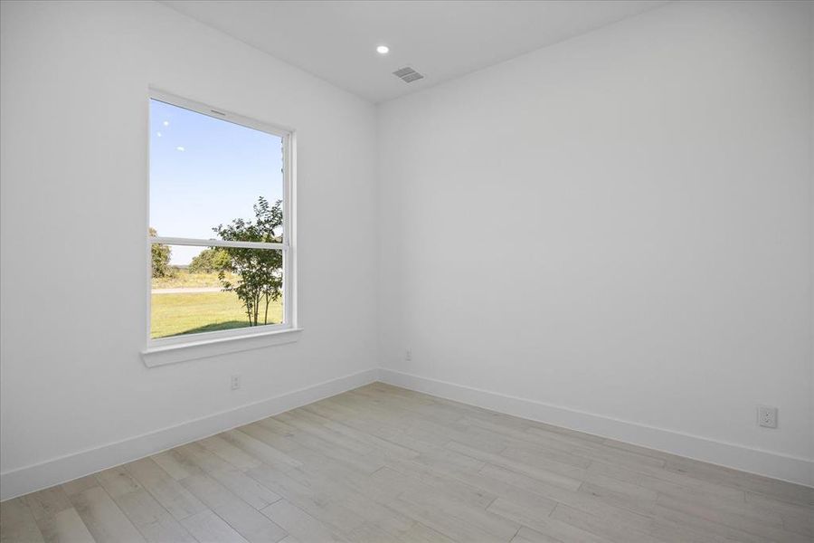 Front facing Study Room featuring a large window, light Porcelain Tile-finish flooring, white walls, recessed lighting, and white baseboards