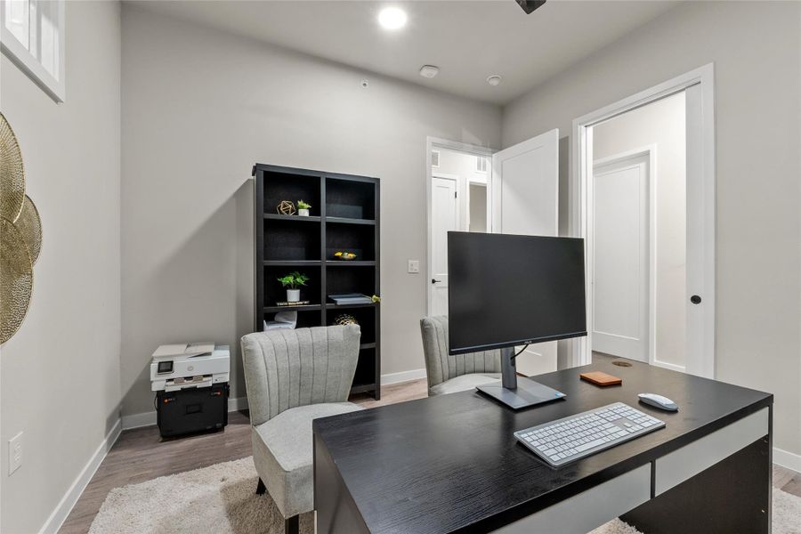 Office featuring wood finished floors and baseboards