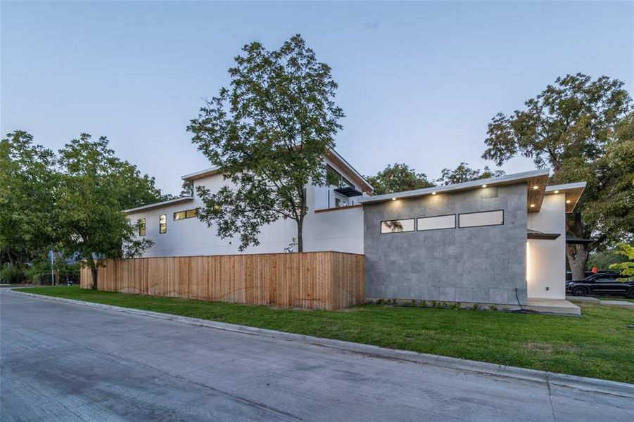 View of side of home featuring a yard