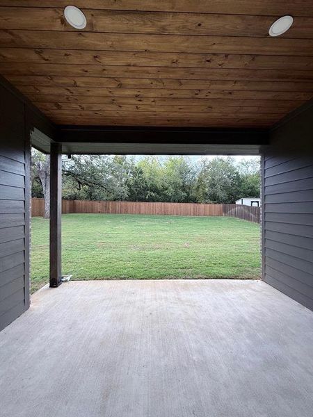 Fenced backyard with a patio area