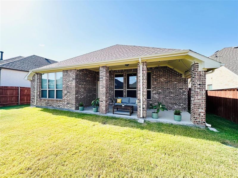 Rear view of house with an outdoor living space, a yard, and a patio