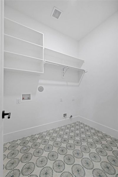 Laundry room with attractive tile and ample storage. Laundry room with attractive tile and ample storage.