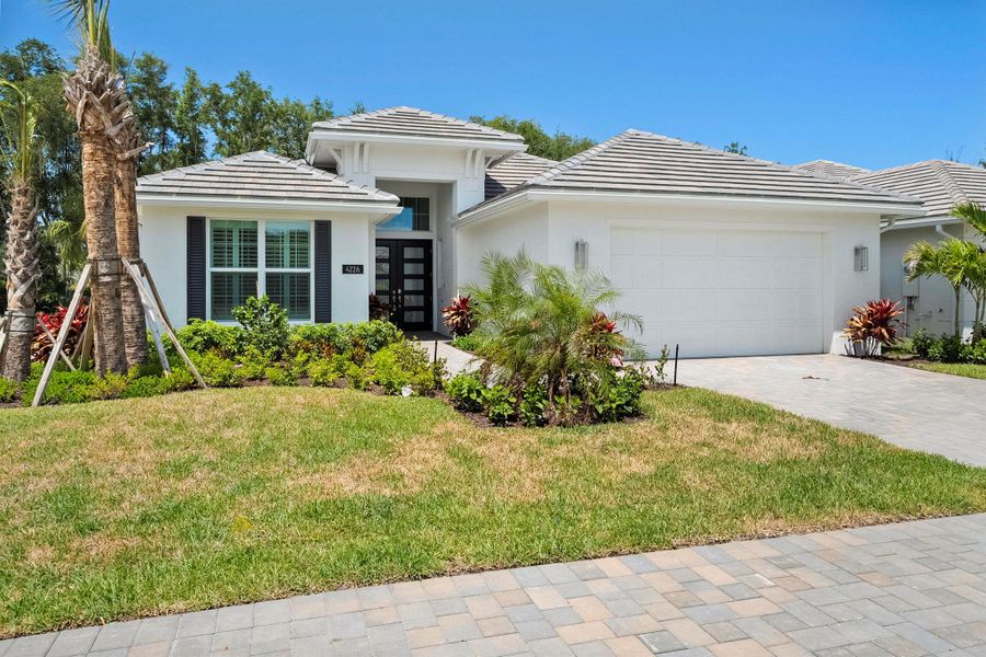 Front exterior of a new home in Lucaya Pointe, Vero Beach, FL, highlighting curb appeal (Image 2).
