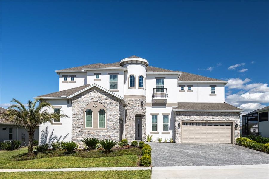 Front exterior of a new home in Avalon Ridge, Winter Garden, FL, highlighting curb appeal (Image 2).