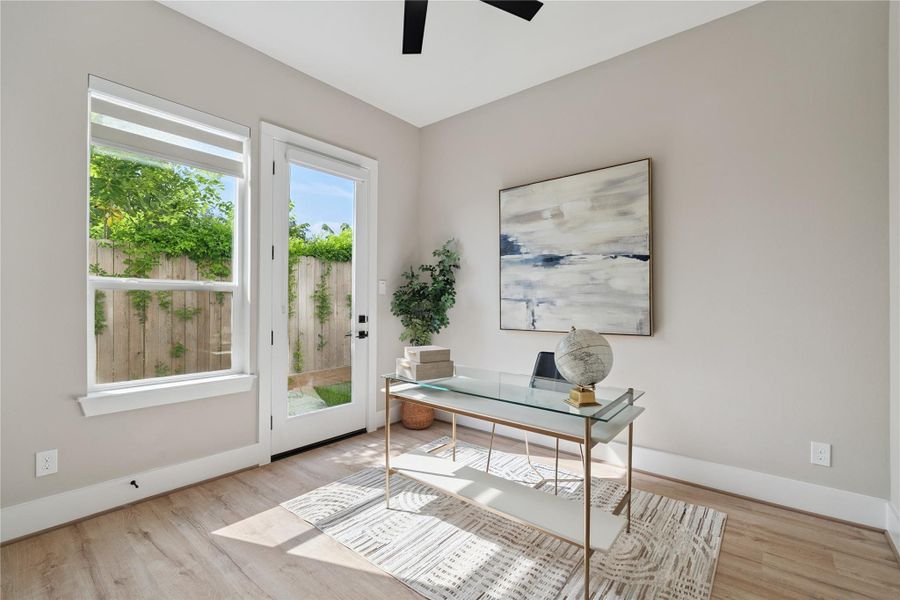 Framed by full-light windows and garden views, this flexible suite invites work or rest in a calm, neutral envelope.