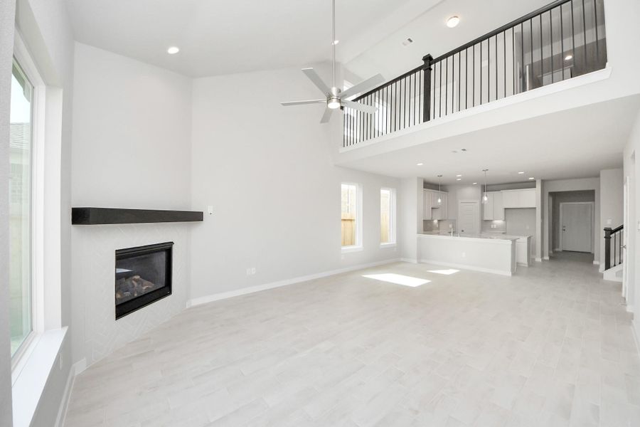 Relax and unwind in this inviting family room, illuminated by abundant natural light streaming in through tall windows, complemented by high ceilings and stunning flooring. Stay comfortable year-round with the gentle breeze from the ceiling fan, creating the perfect atmosphere for family gatherings. Relax and unwind in this inviting family room, illuminated by abundant natural light streaming in through tall windows, complemented by high ceilings and stunning flooring. Stay comfortable year-round with the gentle breeze from the ceiling fan, creating the perfect atmosphere for family gatherings.