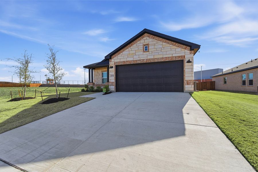 Front exterior of a new home in Pebblebrook, Sherman, TX, highlighting curb appeal (Image 25).