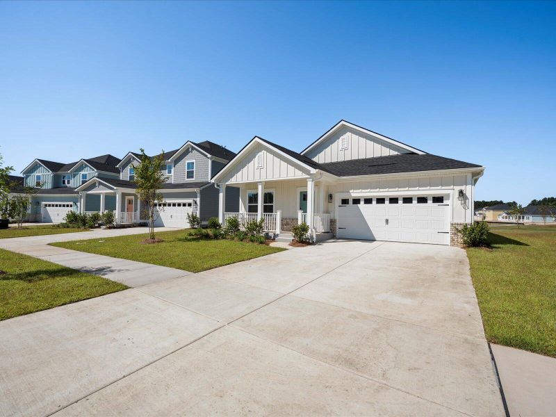 Front exterior of a new home in The Coves at Lakes of Cane Bay, Summerville, SC, highlighting curb appeal (Image 25). Front exterior of a new home in The Coves at Lakes of Cane Bay, Summerville, SC, highlighting curb appeal (Image 25).
