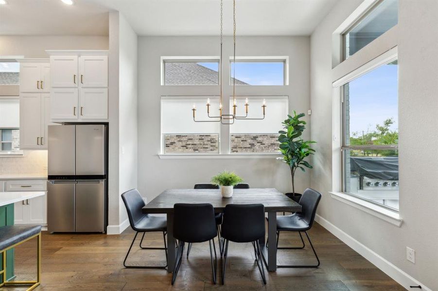 Dining area with an inviting chandelier and dark hardwood / wood-style floors