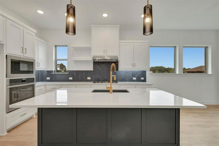 Modern kitchen island featuring a light-toned countertop and contrasting dark cabinetry
