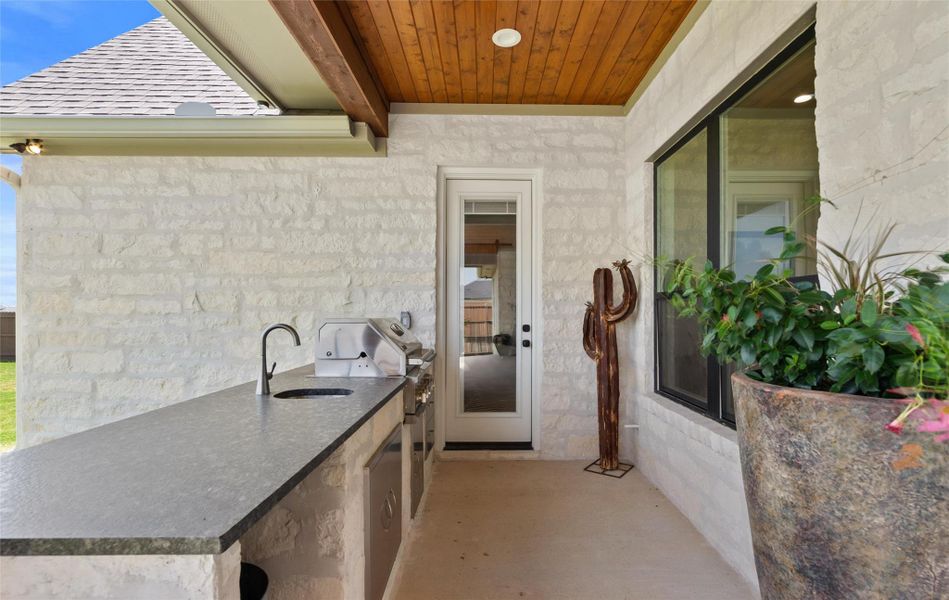 MAZING VAULTED COVERED BACK PORCH with built in outdoor kitchen including GRILL AND SINK. MAZING VAULTED COVERED BACK PORCH with built in outdoor kitchen including GRILL AND SINK.