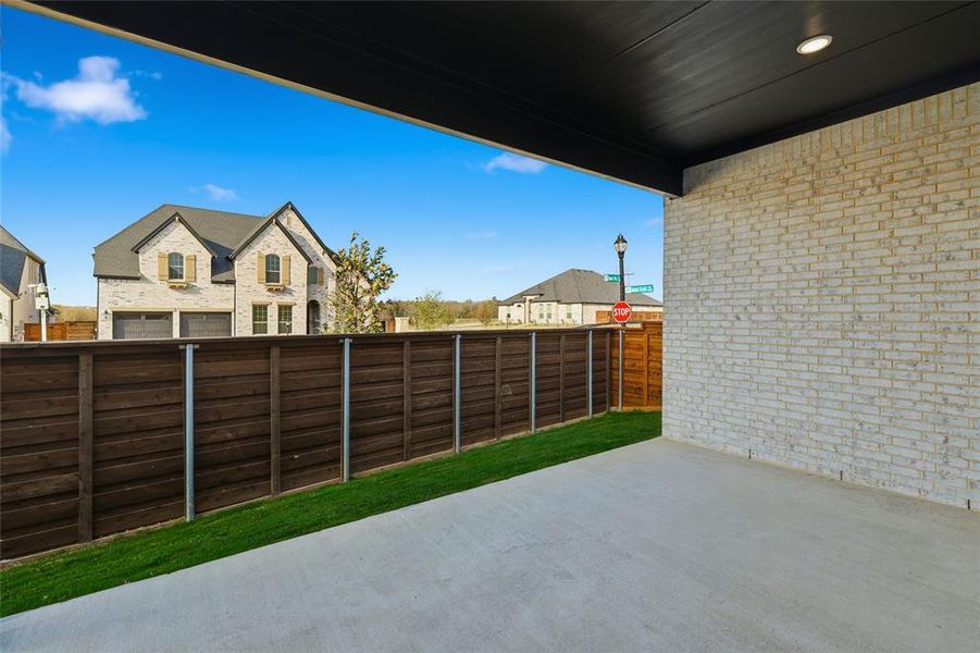Fenced backyard with a patio