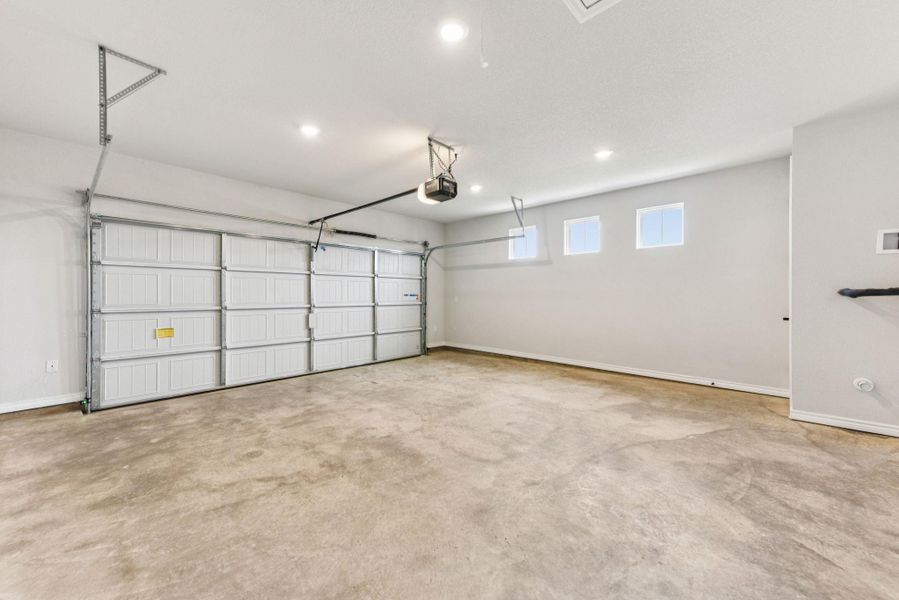 Garage featuring recessed lighting and a garage door opener