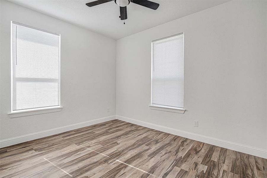 Unfurnished room featuring ceiling fan and light hardwood / wood-style flooring