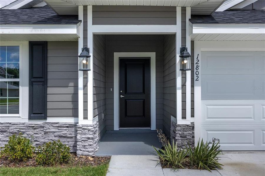 Front exterior of a new home in Savannah Station, Alachua, FL, highlighting curb appeal (Image 12).