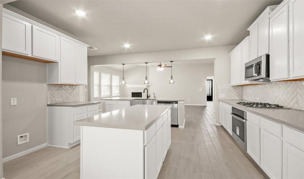 Kitchen with island (*Photo not of actual home and used for illustration purposes only.)