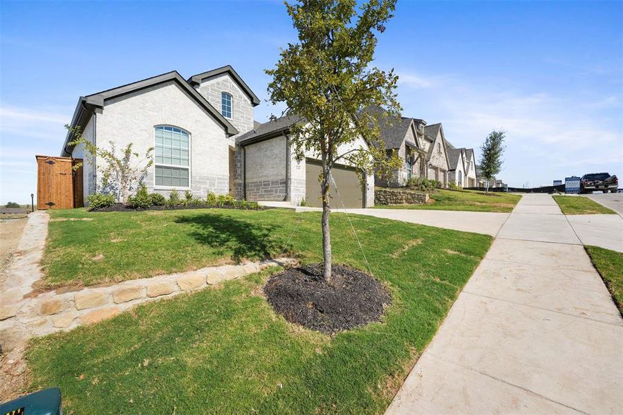 View of front facade with a front yard and a garage