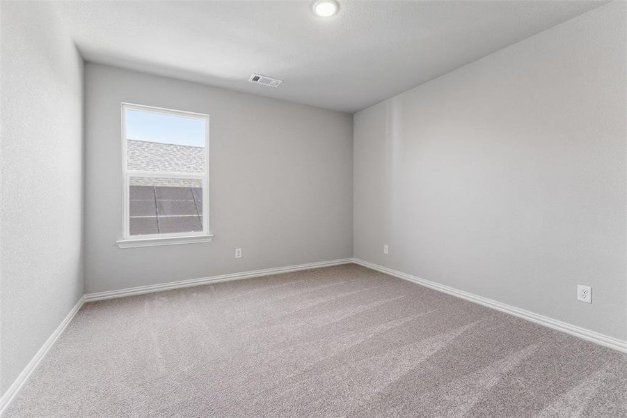 Unfurnished room with light colored carpet and baseboards
