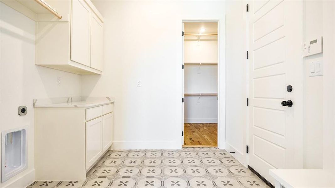 Laundry room featuring cabinets