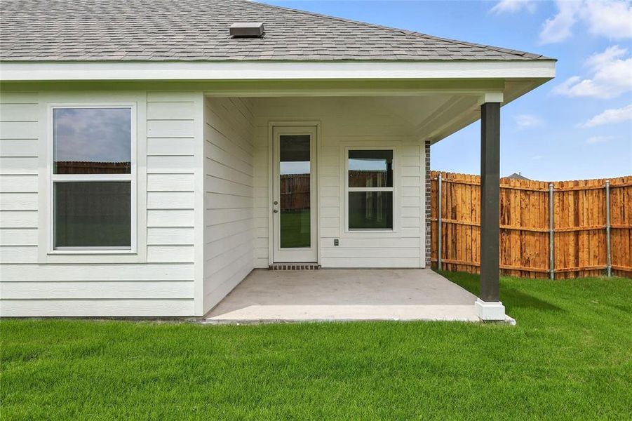 Back of house with roof with shingles and a patio area Back of house with roof with shingles and a patio area