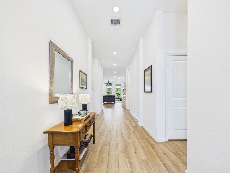 Upon entry you are greeted with a flood of natural light, beautiful LVP flooring throughout the entire home and a spacious foyer leading to your living, dining and kitchen. To the right is a hall closet, 2 bedrooms with walk-in closets and a full sized bathroom.