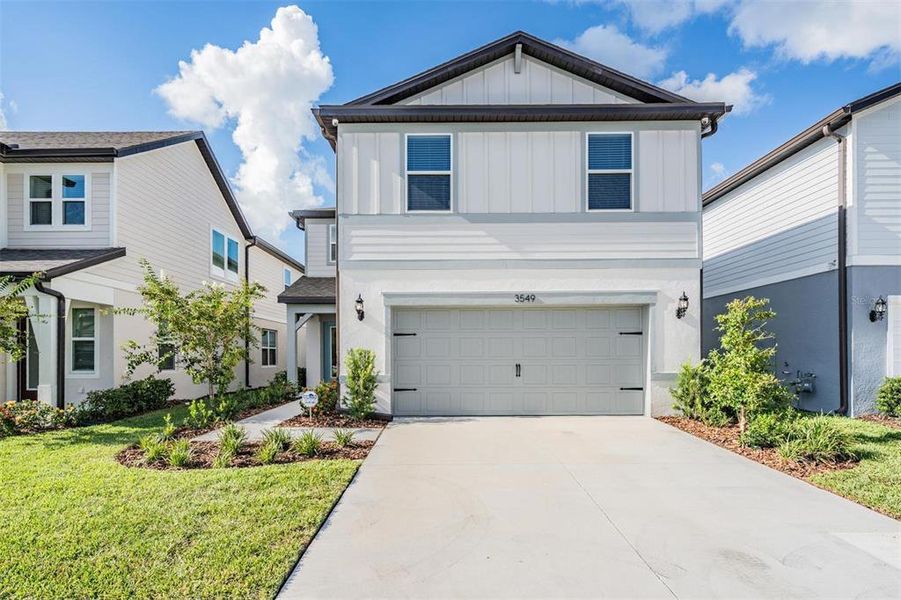Front exterior of a new home in , Land O' Lakes, FL, highlighting curb appeal (Image 23).