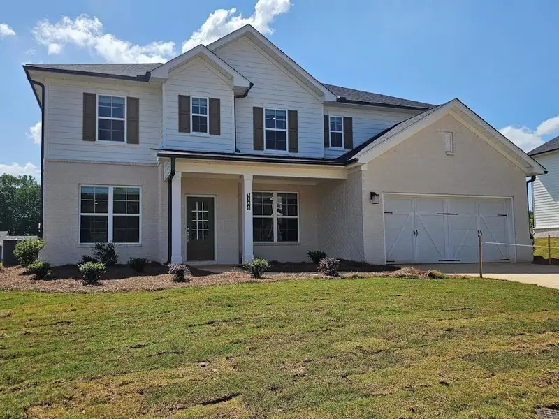 Front exterior of a new home in Ellorie Estates, Dawsonville, GA, highlighting curb appeal (Image 1). Front exterior of a new home in Ellorie Estates, Dawsonville, GA, highlighting curb appeal (Image 1).
