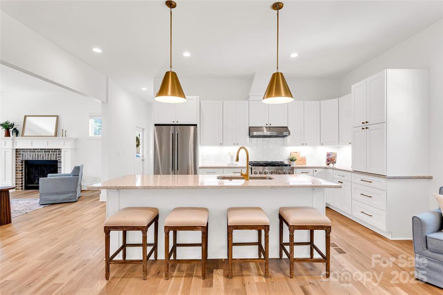 Custom cabinetry, quartz countertops and exquisite lighting package