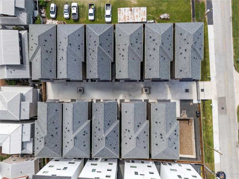 A paved driveway runs between the buildings, leading to individual garages, offering secure and convenient access. A paved driveway runs between the buildings, leading to individual garages, offering secure and convenient access.